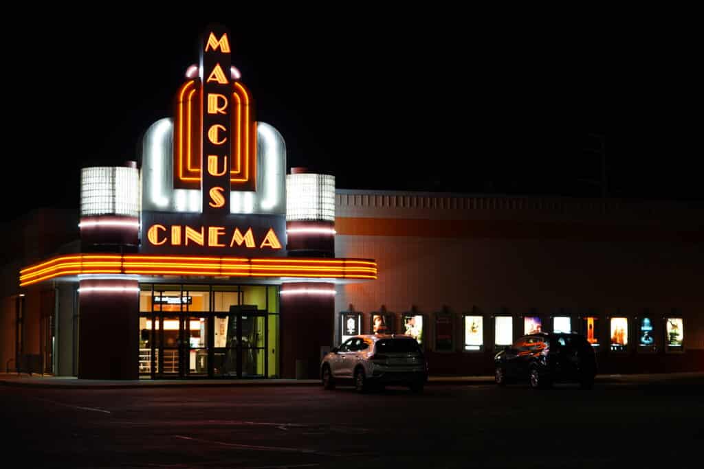 Marcus Cinema Theater sign glows at night.